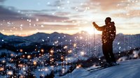 Man in winter clothing standing on snowy mountain slope at sunset, holding ski poles, surrounded by glowing light particles and bokeh effects, representing winter sports and outdoor adventure.
