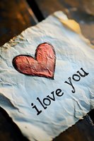 Handwritten love message with red heart on vintage paper for romantic greeting cards and Valentine's Day designs.