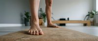 Male feet in downward dog yoga pose on cork mat indoors, fitness and wellness concept for exercise routines and meditation practice.