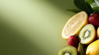 Assorted fresh fruits including lemon slices, kiwi, strawberries and citrus arranged on green background for healthy eating and nutrition content.