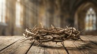 Crown of thorns resting on wooden surface inside ancient stone cathedral with arched windows and warm light streaming through, symbolizing sacrifice and redemption.
