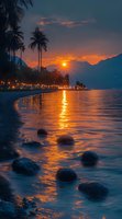 Tropical beach at sunset with palm trees, illuminated promenade, and golden sun reflecting on calm water, ideal for travel and nature backgrounds.