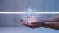 Hands holding glowing holographic human figure with digital network connections representing healthcare technology, medical innovation and futuristic wellness concepts.