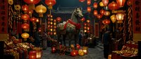 Asian street decorated with red and gold lanterns, traditional ornaments, and festive lights during lunar new year celebration in evening atmosphere.
