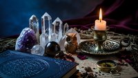 Mystical altar setup with crystals, candle, ancient book and spiritual tools for meditation, divination and esoteric practices.