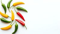 Colorful hot chili peppers arranged in circular pattern on white background. Fresh spicy vegetables for cooking, seasoning and culinary designs.