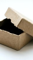 Open brown cardboard box with black interior on white background for packaging and shipping concepts.
