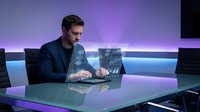 Professional businessman using futuristic holographic interface technology in modern office environment for digital innovation and data analysis.