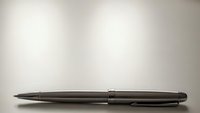 Elegant black ballpoint pen lying horizontally on clean white surface with soft gradient background for professional business writing needs.