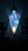 Glowing holographic human organs heart lungs brain floating above vintage light bulb in dark room with pendant lamp creating futuristic medical innovation concept.