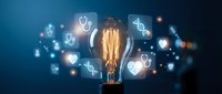 Glowing vintage Edison bulb with medical healthcare icons floating around on dark blue background for innovation and technology concepts.