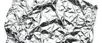 Crumpled silver foil texture with wrinkled metallic surface, suitable for backgrounds, overlays, and design projects requiring reflective materials.