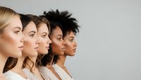 Diverse group of women in profile showing different ethnicities and skin tones representing unity, diversity and inclusion in modern society.