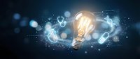 Glowing light bulb surrounded by floating medical icons and stethoscopes on dark blue background representing healthcare innovation and medical technology solutions.