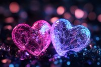Two glowing crystal hearts in pink and blue colors with bokeh background create romantic mood for Valentine's Day designs and love-themed projects.