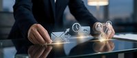 Professional businessman touching digital communication icons on modern tablet screen in corporate office environment for business technology solutions.