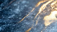 Abstract golden paint brush strokes on dark textured surface with shimmering particles and artistic flowing lines for creative design projects.