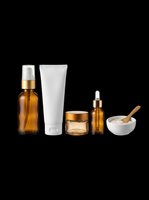 Skincare and cosmetic product bottles with amber glass spray, white tube, golden jar, dropper vial, and ceramic mortar with wooden pestle isolated on transparent background, ready for t-shirt design, clipart, stickers, and print-on-demand projects.