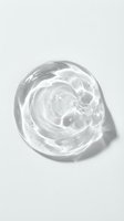Clear gel or serum in petri dish with swirling texture and bubbles, isolated on white background for skincare, cosmetics, and beauty product design use.