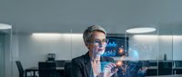 Professional businesswoman analyzing holographic data charts and graphs in modern office environment for corporate technology presentations.