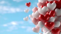 Red and white heart shapes floating against blue sky background, romantic composition with soft focus effect creates dreamy Valentine's Day atmosphere.