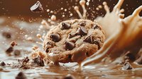 Chocolate chip cookie with milk splash and flying drops in dynamic motion against brown background, dramatic food photography with freeze action.