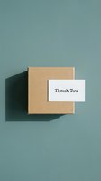 Kraft gift box with a thank you card on a muted teal background, top view. Minimalist packaging concept for small business and e-commerce.