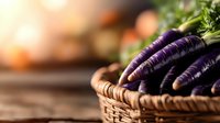 Fresh purple carrots in woven basket against blurred rustic background. Organic farm vegetables with green tops showcase unique variety and natural produce.