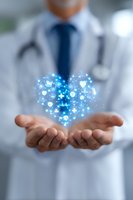 Medical professional in white coat holding glowing blue heart hologram with healthcare symbols, representing modern medicine and patient care technology.