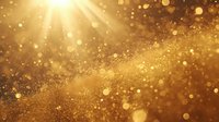 Golden glitter particles with sunbeams shining through creating magical bokeh effect on warm amber background.