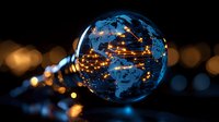 Glowing light bulb with world map pattern illuminated by warm lights against dark background with bokeh effect creates magical global connectivity concept.