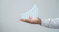 Business professional hand presenting glowing growth chart with ascending bars showing financial success and progress for corporate presentations.