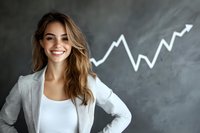 Young businesswoman in white blazer smiling confidently with growing chart drawn on dark chalkboard background showing success and positive business growth.