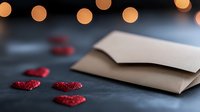 Red glitter hearts scattered near open envelope on dark background with blurred bokeh lights, romantic Valentine's day composition for love letters and cards.