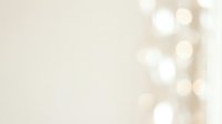 Soft beige background with warm golden bokeh lights creating elegant blur effect for luxury presentations and romantic designs.