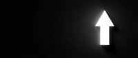 White upward arrow glowing on dark background, symbolizing growth, progress, and success for business presentations and marketing materials.