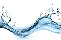 Dynamic water splash with flowing waves and droplets isolated on white background for refreshing beverage and hydration design concepts.