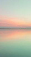 Serene dawn seascape with soft pastel gradient sky reflecting on calm water, ideal for wellness, travel, and lifestyle design projects.