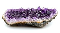 Raw amethyst crystal cluster with deep purple crystalline formation on white quartz base showing natural geological structure and mineral growth patterns.