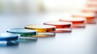 Colorful laboratory petri dishes arranged in diagonal line on light background showing scientific research progression and medical testing concept.