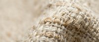 Natural jute rope texture with woven fibers in beige and brown tones for rustic craft projects and nautical designs.