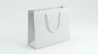 White paper shopping bag with rope handles isolated on light background for retail branding and commercial design projects.