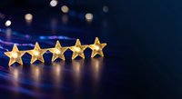 Five golden stars in row on dark surface with bokeh lights background representing excellence rating and premium quality service evaluation.