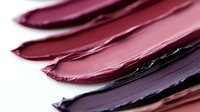 Colorful lipstick smears in pink purple burgundy shades on white background. Cosmetic makeup texture swatches for beauty industry advertising campaigns.