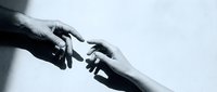 Two hands reaching toward each other in black and white, fingertips nearly touching, evoking connection, hope, and human bond.