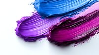 Vibrant cosmetic smears showing blue, purple, and pink cream texture swatches on white background, demonstrating makeup product consistency and pigmentation.