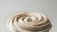 Creamy swirl of whipped cream or frosting with cocoa powder dusting on neutral background for dessert and baking projects.