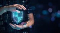 Hands protecting glowing digital shield symbol representing cybersecurity, data protection, and network safety for technology and business security concepts.