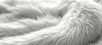 Luxurious white fur texture with soft fluffy fibers creating gentle waves and shadows, natural animal fur background pattern for fashion and textile design projects.