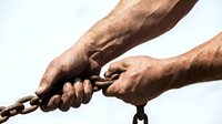 Strong male hands gripping heavy metal chain against white background symbolizing strength, determination, and breaking free from constraints.